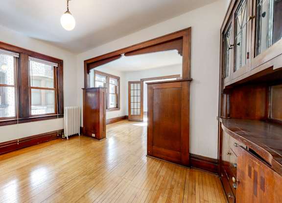 A room with wooden floors and a large wooden door.