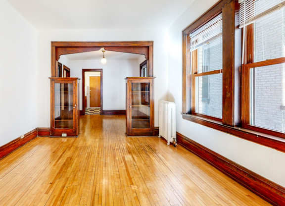 A room with wooden floors and white walls.