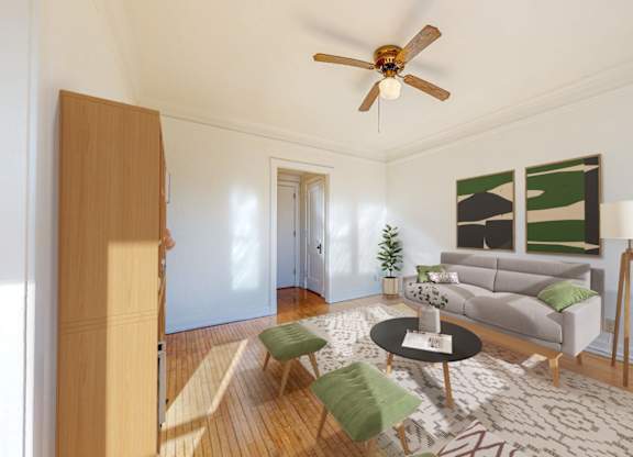 A living room with a grey couch, a coffee table, and a ceiling fan.