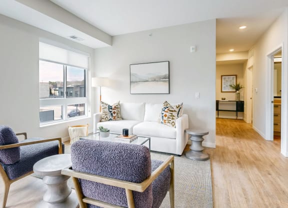 a living room with a couch and chairs and a table