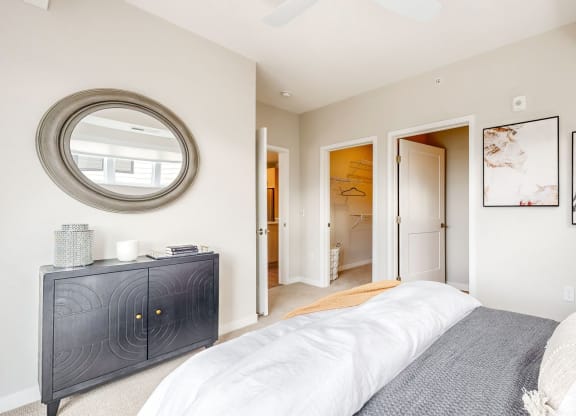 a bedroom with a large bed and a mirror