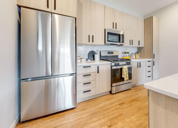 a kitchen with stainless steel appliances and white cabinets