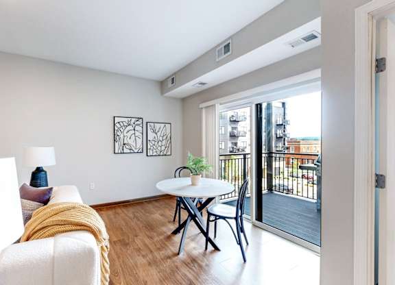 A living room with a white couch and a small table.