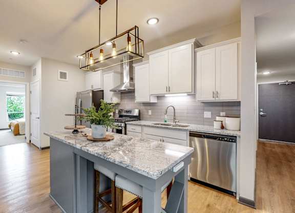 A modern kitchen with a large island in the center.