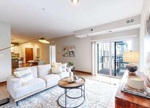 A living room with a white sofa and a coffee table.