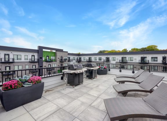 rooftop patio at the yards and backyards apartmens with sun chairs and planters