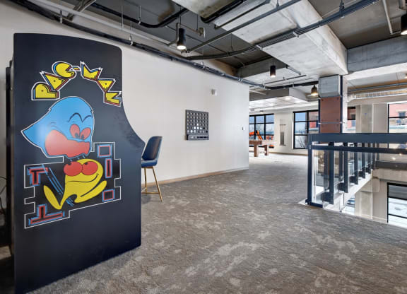 Pac Man game in a room with a staircase in the at The Yards and Backyards, MN 55075