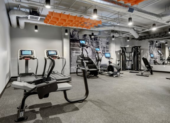 a gym with treadmills and other exercise equipment in a building