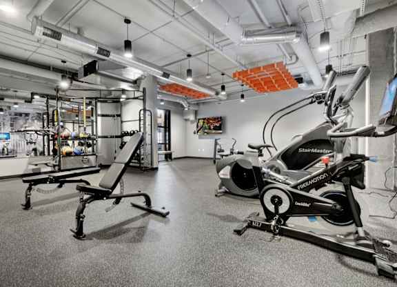 fitness center with black rubber floors, strentgth and cardio equipment