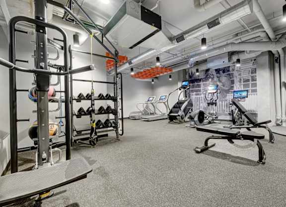 fitness center with black rubber floors, strentgth and cardio equipment