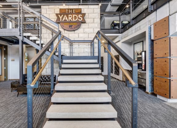 the stairs at the yards with a sign on the side of the building