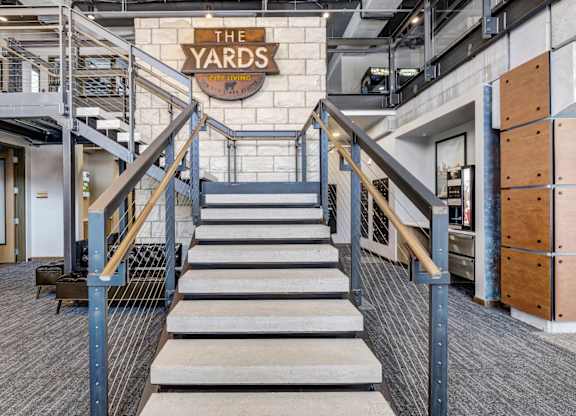 a staircase with a large sign that says the yards on the top of it