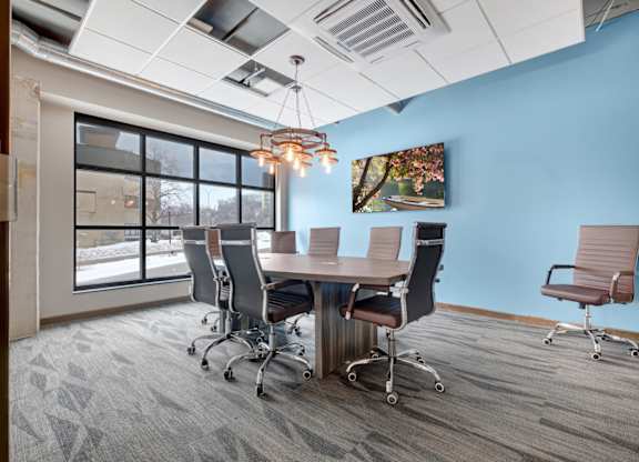a conference room with blue walls and a large window