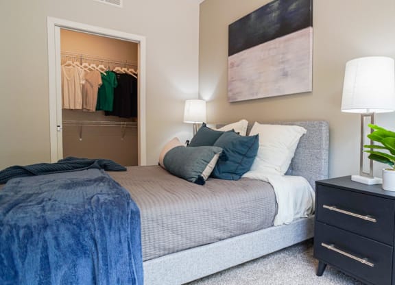 a bedroom with a bed and a dresser with a plant at The Yards and Backyards, Minnesota