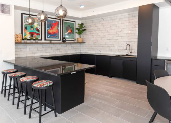 a kitchen with a black island and bar stoolsat Tyler Street Stacks, Minneapolis Minnesota