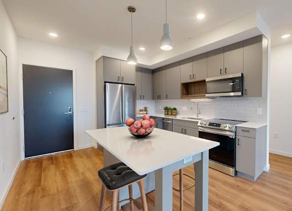 A modern kitchen with a dining table and chairs.at Tyler Street Stacks, Minneapolis, MN