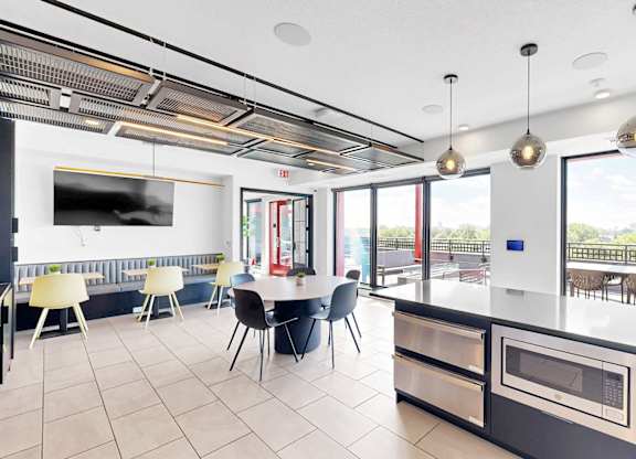 A modern kitchen with a dining table and chairs.