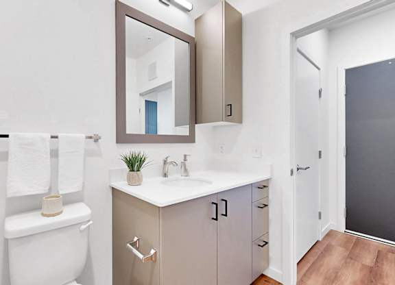 A white toilet sits next to a sink in a small bathroom.