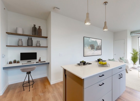 a kitchen with an island and a living room with a balcony at Tyler Street Stacks, Minneapolis