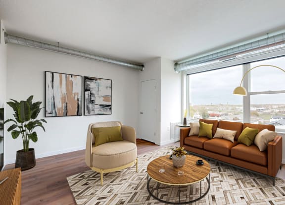 a living room with a couch and a large window at Tyler Street Stacks, Minnesota, 55413