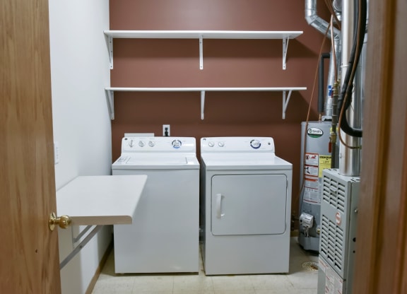 Laundry room with full size washer and dryer and shelving