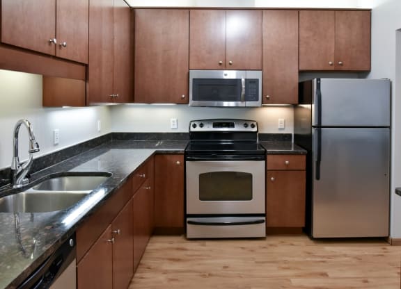 traditional kitchen with cherry cabinets and dark granite countertops