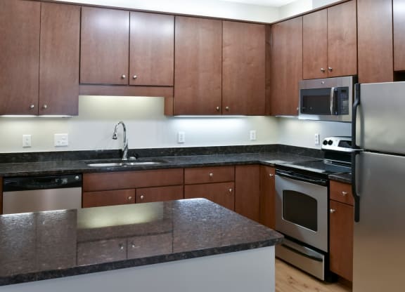 traditional kitchen with cherry cabinets and dark granite countertop