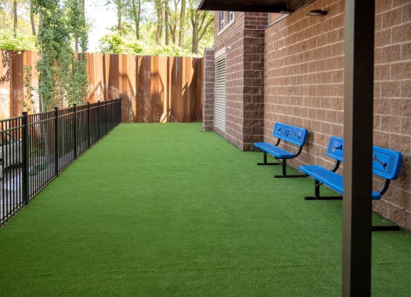 Outdoor dog run with artificial turf and benches at Victoria Flat, Victoria, MN