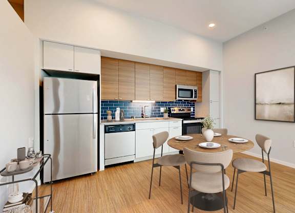 A modern kitchen with a dining table set for four.