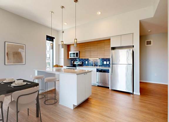 A modern kitchen with a dining table and chairs.