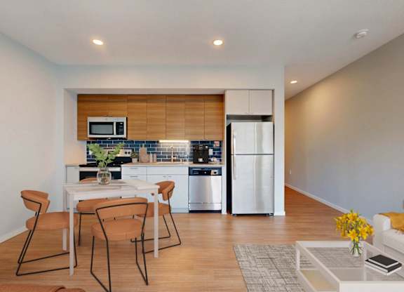 A modern kitchen with a dining table and chairs.