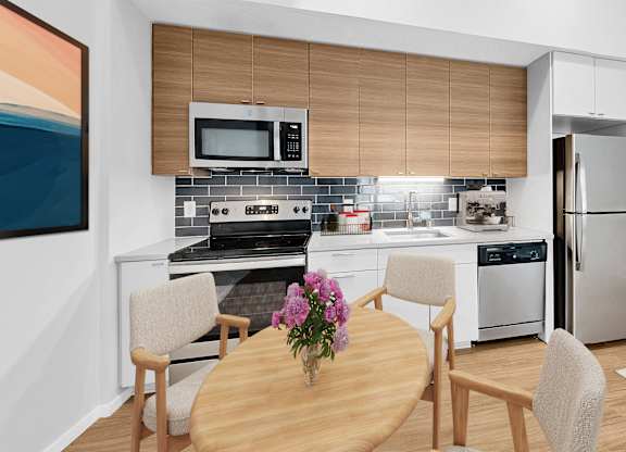 A modern kitchen with a wooden table and chairs.