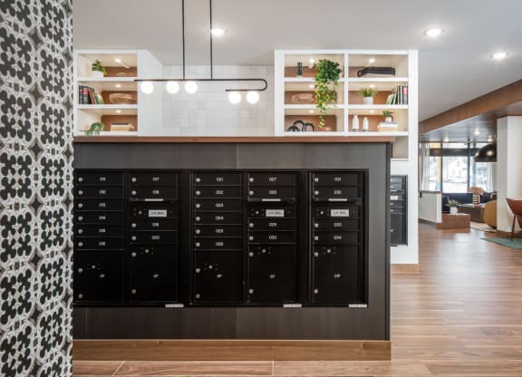 a view of the mail room with a large collection of mailboxes