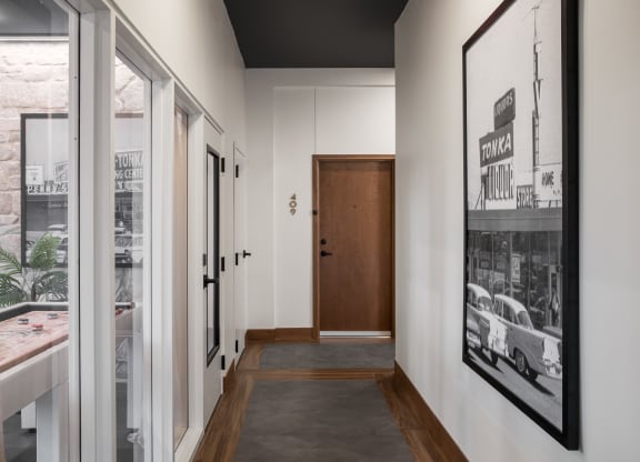 a view down the hallway of a house with white walls and a black ceiling