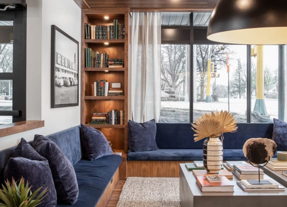 a living room with a blue couch and a coffee table