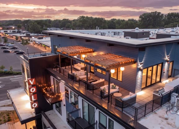 an aerial view of a building with a rooftop patio and a hotel sign
