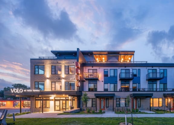 a view of the yolo apartments at dusk