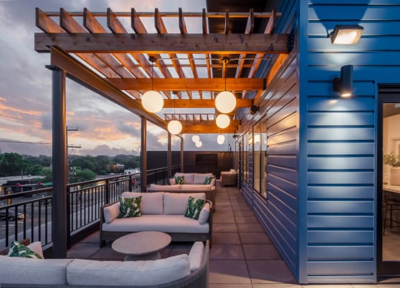 a balcony with couches and a table
