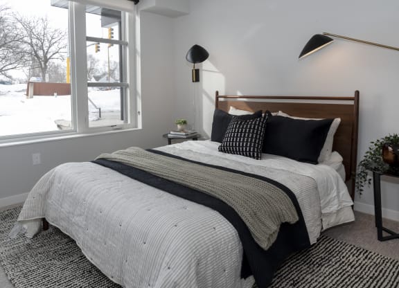 a bedroom with a bed and a window