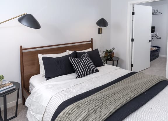 a bedroom with a bed and two lamps
