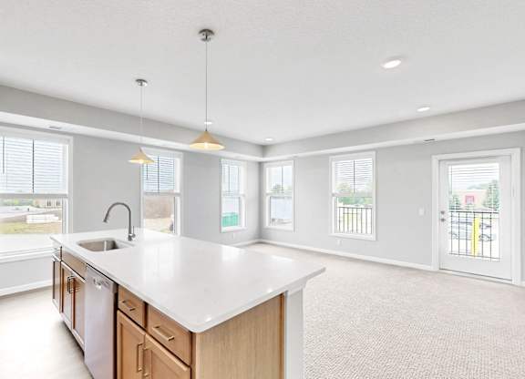 A kitchen with a large island and a sink.