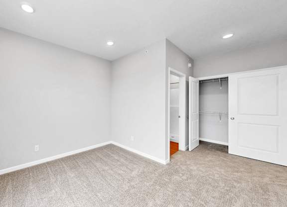 A room with a carpeted floor and white walls.