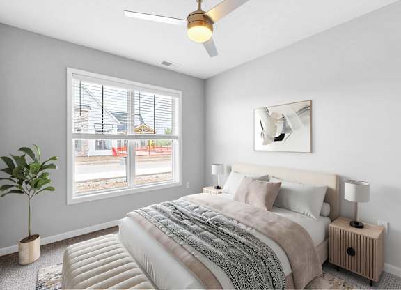 A bedroom with a large bed, a ceiling fan, and a window with a view of a street.