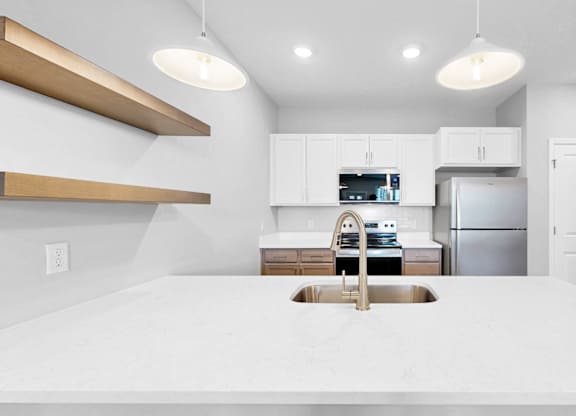 A modern kitchen with a large island in the center.