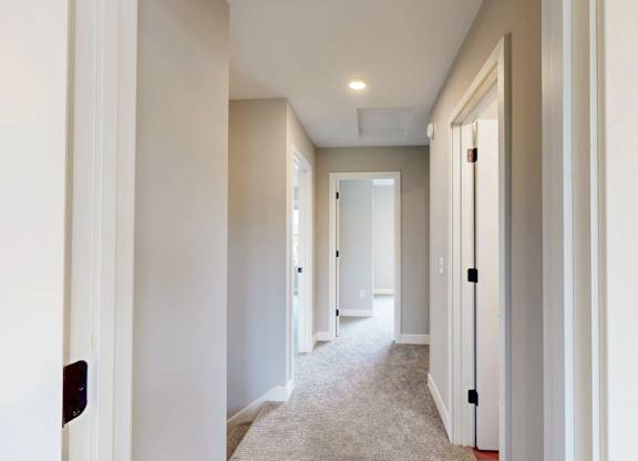 Upstairs hallway with carpeting and recessed lighting at Wildwood Lakeville Apartments, Lakeville, Minnesota