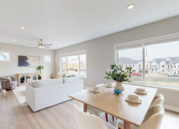 Open dining and living space with large windows at Wildwood Lakeville Apartments, Minnesota, 55044