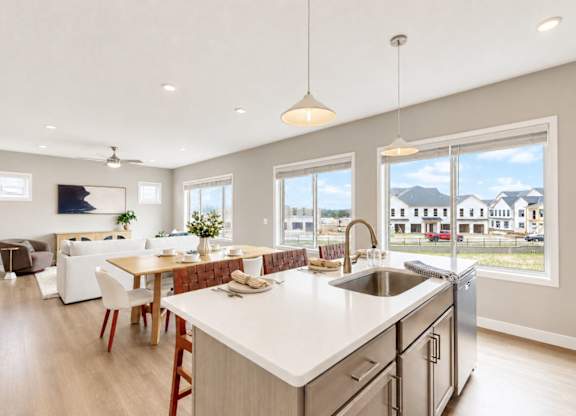 Kitchen island with sink and large windows at Wildwood Lakeville Apartments, Lakeville, MN 55044
