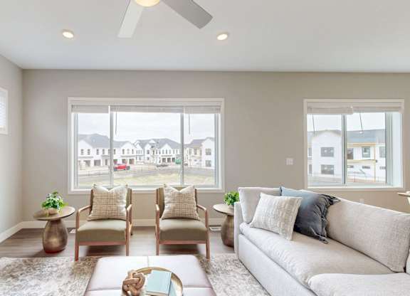 Contemporary living room with armchairs and modern decor at Wildwood Lakeville Apartments, Lakeville
