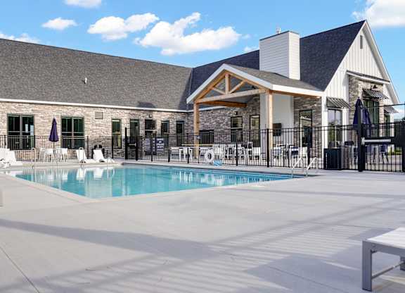 A large outdoor swimming pool with a building in the background.