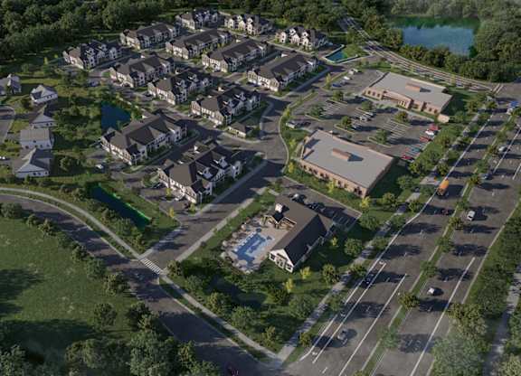 Aerial view of residential community with parking and pond at Wildwood Lakeville Apartments, Lakeville, MN
